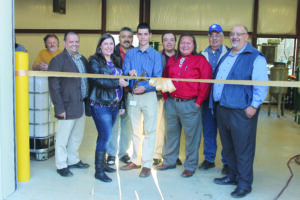 A ribbon cutting was held for the new biodiesel facility located behind the Cherokee Transportation Center on Wednesday, Dec. 19.  Shown (left-right) John McClellan, Verdi Bio-Trailers; Tommy Lambert, Cherokee Boys Club general manager; Katie Tiger, EBCI Office of Environment & Natural Resources; Jamie Long, EBCI Office of Environment & Natural Resources manager; Damon Lambert, EBCI Building Construction  manager; Big Cove Rep. Bo Taylor; Cherokee County – Snowbird Rep. Diamond Brown, Jr.; Wilbur Paul, Cherokee Boys Club Board president; and Big Cove Rep. Perry Shell.   (SCOTT MCKIE B.P./One Feather photos) 