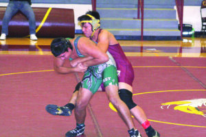 Cherokee's Dorian Walkingstick gets the back of East Henderson's Moises Martinez in a match on Saturday, Dec. 15 at the Osley B. Saunooke wrestling tournament.  Walkingstick pinned Martinez en route to a first place finish in the 170lb. weight division.  (DENISE WALKINGSTICK/One Feather contributor photos) 