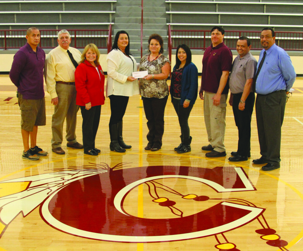 Collette Coggins (4th from left), Tribal ABC Commission Chairman, is shown presenting a check on Jan. 11 in the amount of $125,000 to Lori Blankenship (5th from left), Cherokee School Board chairman.  Shown (left-right) are Pepper Taylor, Steve Coleman, Jody Lipscomb, Coggins, Blankenship, Wolftown School Board Rep. Jessica Daniels, Big Y School Board Rep. Dick Crowe, Cherokee Boys Club general manager Tommy Lambert and Cherokee Central Schools superintendent Walt Swan. (CCS photo) 
