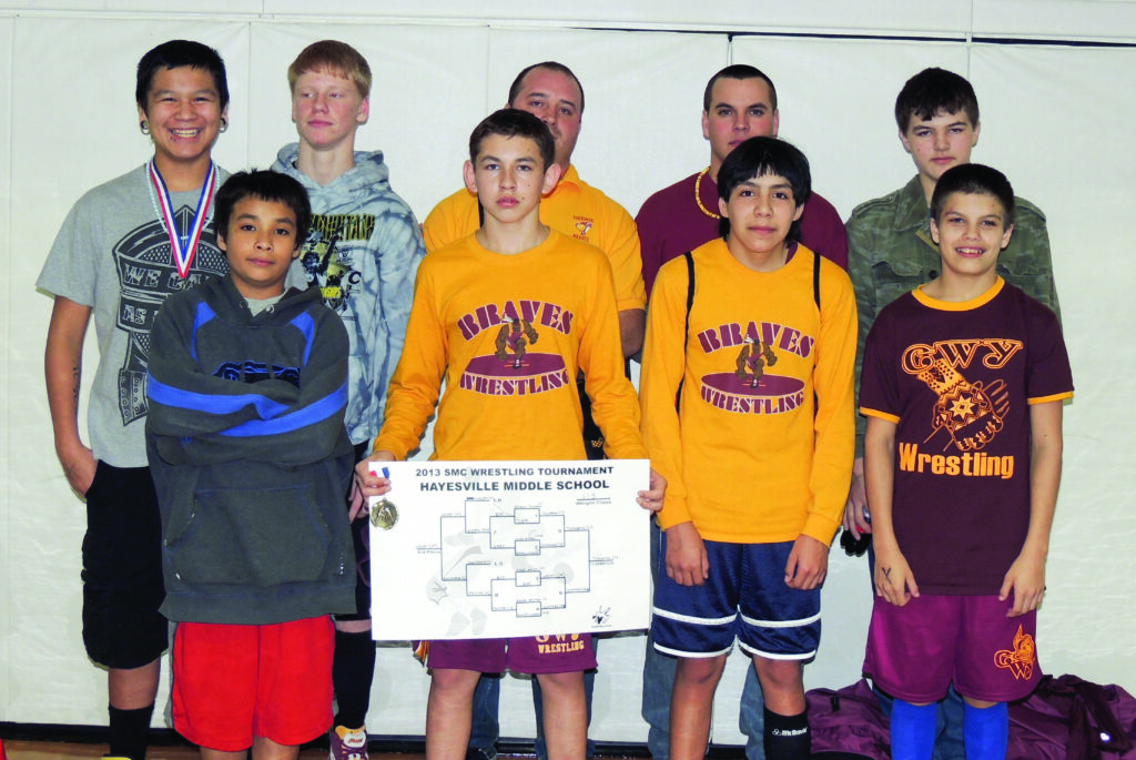 Five members of the Cherokee Middle School wrestling team placed at the Smoky Mountain Conference tournament held at Hayesville on Friday, Feb. 8 including: John Queen, 1st, 106lb.; Anthony Toineeta, 1st, 113lb.; Stephen Muese, 2nd, 120lb.; Luke Woodard, 1st, 145lb.; and John Tramper, 3rd, 160lb.  Shown  (left-right) front row - Xavier Locust, Toineeta, Queen and Seth Sneed; back row – Tramper, Woodcard, CHS coach Will Lambert, CMS coach D.J. Robinson and Andrew Griffin.  (DENISE WALKINGSTICK/One Feather contributor)   