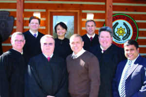 Principal Chief Michell HIcks (first row, center) poses with newly sworn-in Cherokee Tribal Court Judges on Thursday, Feb. 14. Shown (left-right) front row – Steven Philo, Associate Judge of Special Jurisdiction (Drug Court); Danny Davis, Associate Tribal Judge; Chief Hicks; Kirk Saunooke, Associate Tribal Judge; Roy Wijewickrama, District Court Judge 30A Judicial District; back row – Brad Letts, an EBCI tribal member who serves as the Senior Resident Superior Court Judge for the 30B Judicial District of North Carolina; Brenda Toineeta Pipestem, Associate Justice, Cherokee Supreme Court; and William Boyum, Chief Justice, Cherokee Supreme Court. (LYNNE HARLAN/EBCI Public Relations)