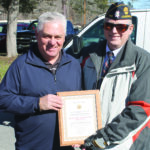 Post 143 Commander Lew Harding (right) presents a plaque of appreciation to Chairman Jim Owle. 