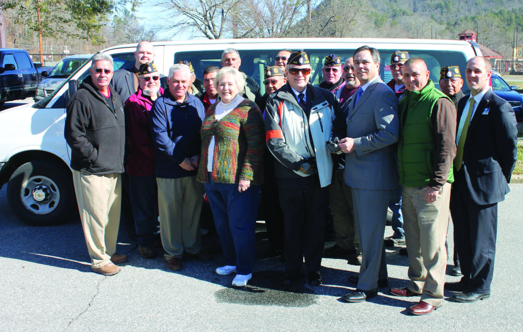 Harrah’s Cherokee donated a 15-passenger van to the Steve Youngdeer American Legion Post 143 on Friday, Feb. 1.  Here, Lumpy Lambert (3rd from right, front row), Harrah’s Cherokee assistant general manager, presents the keys to Post 143 Commander Lew Harding (4th right, front row) as tribal officials, Harrah’s officials and Post 143 members look on. (SCOTT MCKIE B.P./One Feather photos) 