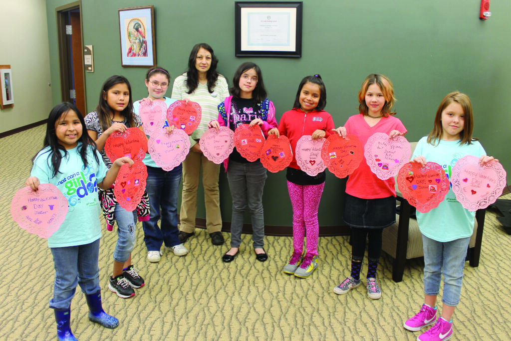 Members of the Junior Girl Scout Troop 30341, based in Cherokee, made Valentine’s Day doilies that were given as presents to senior citizens at Tsali Manor.  The girls, all students at Cherokee Elementary School, are shown with the doilies on Wednesday, Feb. 13.  Shown (left-right) are Ryan Junaluska, Syrena West, Keara Cline, troop leader Charlene Stiles, Jaia Watty, Rabekka Wolfe, Trixie Tramper and Shoni Panther.  (SCOTT MCKIE B.P./One Feather)  