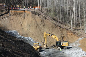 Reporters from Tennessee, shown on the far bank, give some depth and scale to the enormity of the landslide area.  