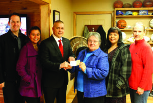 The North Carolina Chapter of the Trail of Tears Association donated $5,000 to the Remember the Removal bike ride on Thursday, Feb. 21.  Shown (left-right) are Jeremy Hyatt, 2012 rider; Sheena Kanott, 2011 rider; Principal Chief Michell Hicks; Carmaleta Monteith, Chapter vice-president; Tara McCoy, 2011 rider; and Anita Finger-Smith, Chapter treasurer. (SCOTT MCKIE B.P./One Feather)