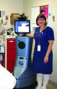 Victoria Harlan, RN, BSN, Cherokee Indian Hospital ER manager, poses with the Telestroke Robot.   (CIH photo)