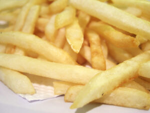 French fries are a food high in fat and cholesterol that should be eaten in small quantities. 