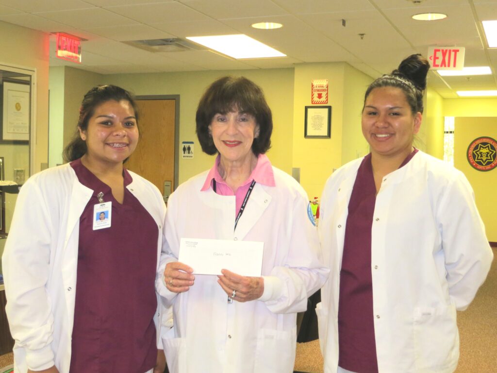 Angel Saine (right) and Brianna Smith (left) joined their instructor, Frances Hess, at Cherokee Indian Hospital last week when she picked up a check from the Cherokee Indian Hospital employees.  Saine and Smith are in the Nursing Fundamentals Class and will be sitting for their CNA I after graduation. Cherokee Indian Hospital employees made a donation to the Health Occupations Students of America.  (CIH photo) 