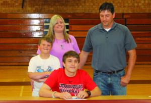 EBCI tribal member Dylan Rose (seated) signed a letter of intent on Friday, May 24 to play baseball next year at Catawba Valley Community College.  He is shown with his family (standing left-right) including – brother Dane Anthony, mother Bree Anthony, and father Albert Rose.  (SCOTT MCKIE B.P./One Feather)