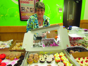 Jeanne Rearick, Harrah's Cherokee Casino Resort income control lead, arranged hundreds of cupcakes baked by employees at the property's Cupcakes for Cures bake sale. Nearly one thousand cupcakes were sold during the event. (Harrah's Cherokee photo) 