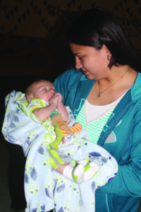 EBCI tribal member Amanda Wolfe Moore holds her two-month-old son Wyatt during the Breastfeeding Awareness Celebration at the Acquoni Expo Center on Wednesday, July 31.  She has exclusively breastfed him since birth.  (SCOTT MCKIE B.P./One Feather photos) 