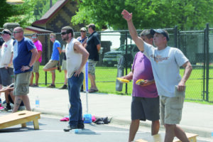 Principal Chief Michell Hicks throws during the Madison Hornbuckle Cancer Foundation cornhole tournament held at the Cherokee Indian Fairgrounds on Friday, Aug. 2.  (SCOTT MCKIE B.P./One Feather) 