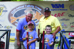 Chairman Jim Owle (back left) and Marty Fourkiller, a Cherokee Nation citizen and professional bass fisherman (back right) pose with the winners of the 3-5 year old division Christen Bartlett (2nd place) and Zack McMinn (3rd place).  Not pictured: Jason Silcoh (1st place)