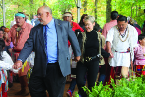 Big Cove Rep. Perry Shell and State Rep. Deb McManus, an EBCI tribal member, participate in the Cherokee Friendship Dance with the Warriors of Anikituwah. 
