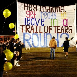 The McAdory High Yellow Jackets played the Pinson Valley Indians on Friday, Nov. 15, and McAdory’s cheerleaders held up a run-through sign prior to the game which read, “Hey Indians, get ready to leave in a Trail of Tears, Round 2.” (Photo credit: Instagram/madisoncain7)