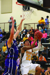 Cherokee’s Darius Thompson (#20) goes around Mitchell’s Austin Mask (#30) for a layup.  He scored 16pts on the night. 