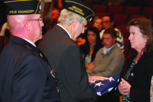 Post 143 Commander Lew Harding presents a flag to April Ledford, the widow of Vice Chief Bill Ledford, at a memorial service honoring Ledford held on Saturday, Nov. 2 as Post 143 service officer Warren Dupree (left) looks on. 