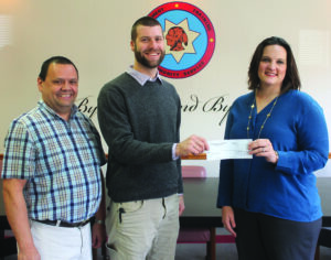 Annette Saunooke Clapsaddle (right), Cherokee Preservation Foundation executive director, presents a matching donation of $200,000 to go towards the construction of the new Cherokee Children’s Home to Cris Weatherford (center), Cherokee Children’s Home director, and Tommy Lambert, Cherokee Boys Club general manager.  (SCOTT MCKIE B.P./One Feather)