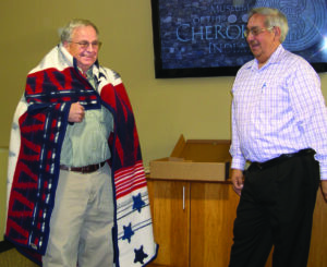 Wilbur Paul (right) presents longtime Museum of the Cherokee Indian executive director Ken Blankenship a Pendleton blanket during his retirement luncheon on Dec. 27.  Blankenship retired after 28 years of service to the Museum.  (Photo by Joyce Cooper/Museum of the Cherokee Indian)