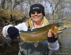 Becky Perkins, of Orlando, Fla., with her first trout on a fly rod, a 23-inch Rainbow Trout from the Oconaluftee River.  (Photo courtesy of Eugene Shuler) 