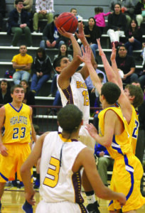 Kennan Panther (#15) shoots a jump shot over two Highlands defenders.  He had 6pts in the game. 