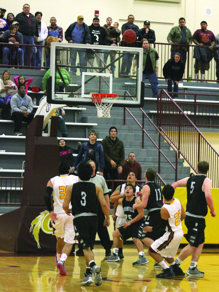 Darius Thompson (#20) makes the game-winning jump shot as his teammates, all of Robbinsville’s players, and every person in the Charles George Arena watches.  