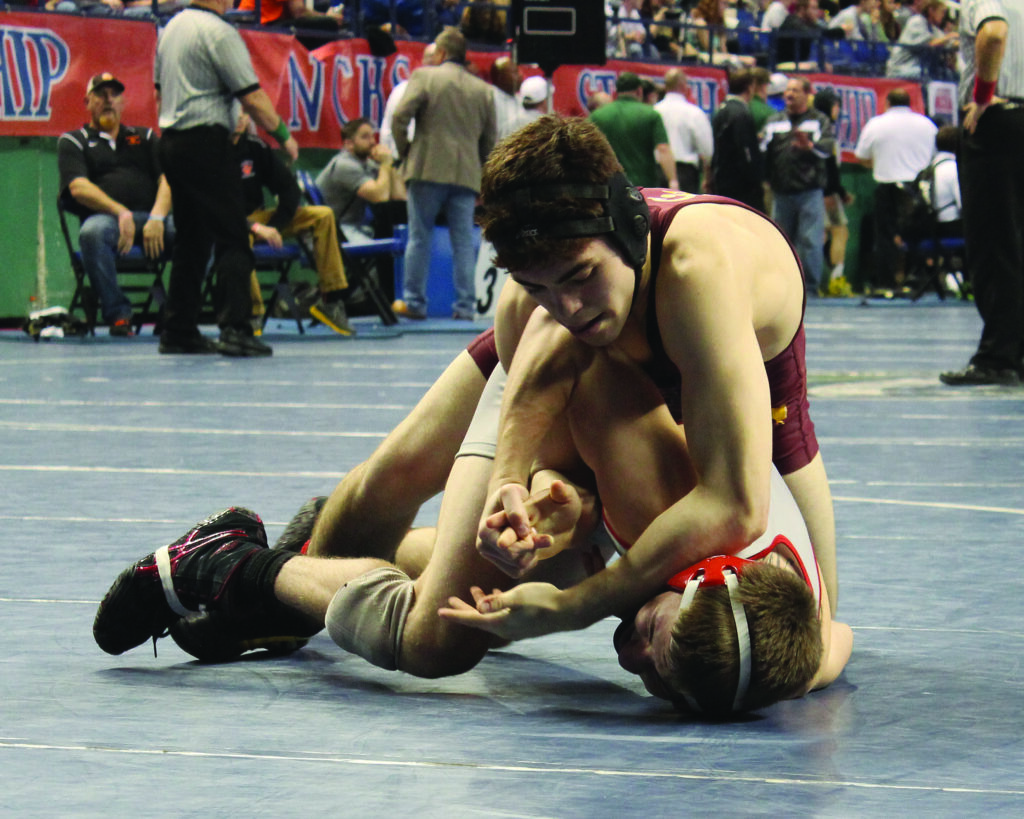 Cherokee’s Levi Swearengin wrestles Chatham Central’s James Dagget, the eventual state champion, in the 126lb division at the 1A state wrestling finals in Greensboro.  Swearengin took fourth place in the division.  (AMBLE SMOKER/One Feather photos) 