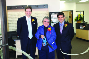 Cherokee Indian Hospital Authority chairperson cuts the ribbon to officially open the new Cherokee Eye Care Clinic in the Yellowhill Community on Wednesday, April 23.  She is flanked by CIHA board member Judge Brad Letts (left) and CIHA CEO Casey Cooper.   (SCOTT MCKIE B.P./One Feather) 