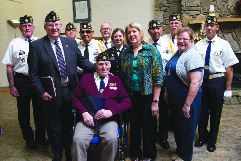 Earl Wood (seated center) and Raymond Pusz’s wife, Mrs. Rosemary Denise Pusz, (standing front beside Wood) are shown with members of the Steve Youngdeer American Legion Post 143 who put together Thursday’s event.  