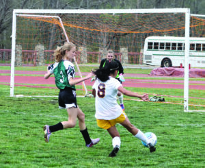 Sophomore forward Sidnie Yanez dribbles by Tallulah Falls’ Linden Pederson to shoot on goal in the second half of Tuesday’s game.  
