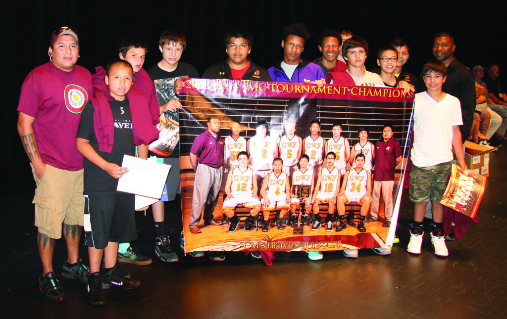 The CMS 2013-14 boys basketball team poses with a banner they were presented with during the CMS Athletic Awards program on Friday, May 23 in commemoration of winning the Smoky Mountain Conference tournament.  (SCOTT MCKIE B.P./One Feather photos) 