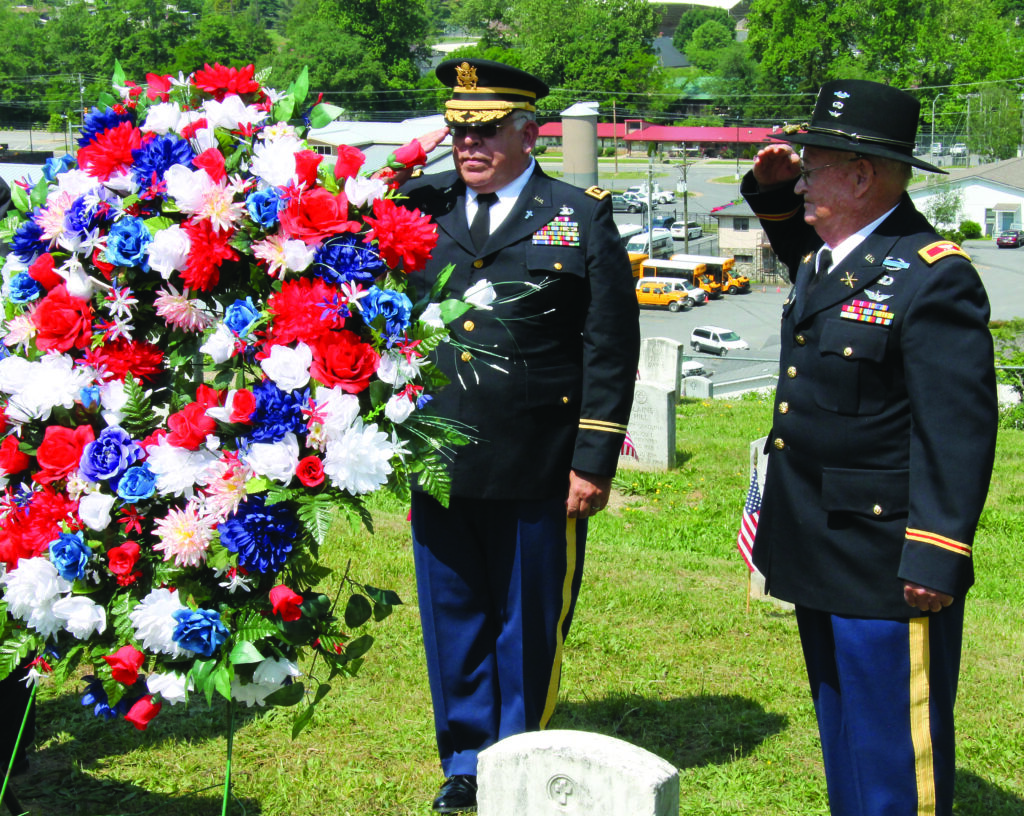 Maj. Bill Underwood (left) and Col. Bob Blankenship salute after the laying of the wreath at the Yellowhill Veterans Cemetery at the Memorial Day observance on Monday, May 26.   (SCOTT MCKIE B.P./One Feather photos) 