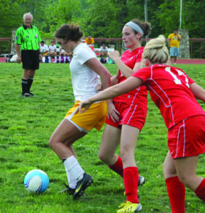 Cherokee senior Avery Mintz (#7) works with the ball against East Wilkes’ Melia Higgins and Brittany Schubart.  