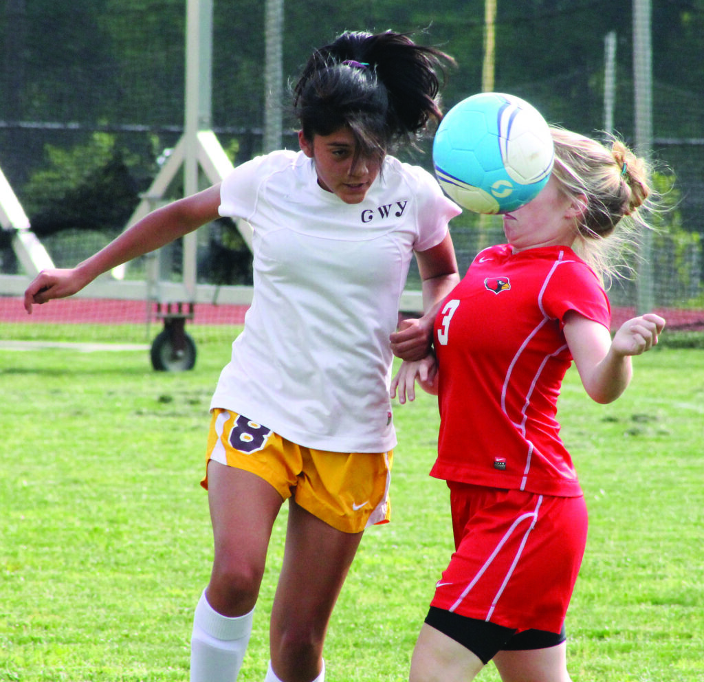 Cherokee sophomore Sidnie Yanez (#8) wins a header against East Wilkes’ Hannah Holbrook during a match at Cherokee on Wednesday, May 14.  (SCOTT MCKIE B.P./One Feather photos) 