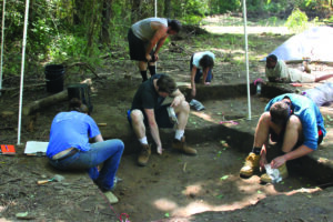 Illinois State University students participating in the month-long Archaeological Field School participate in a dig.  (Photo by Anthony Brown) 