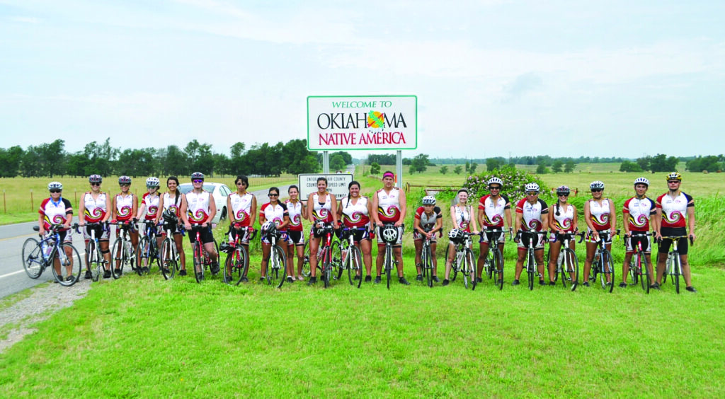 Remember the Removal Riders are shown (left-right) at the Oklahoma state line including: Pat Watkins, Elizabeth Burns, Jamekah Rios, Katie Sneed, Tye Carnes, Chance Rudolph, Zane Scullawl, Adriana Collins, Keeley Godwin, Cassie Moore, Charli Barnoskie, Ty Bushyhead Boyd, Russell Bigmeat, Madison Taylor, Noah Collins, Richie Sneed, Jordan McLaren, Kelsey Owle, Jacob Chavez and Ride Coordinator Joseph Erb. 