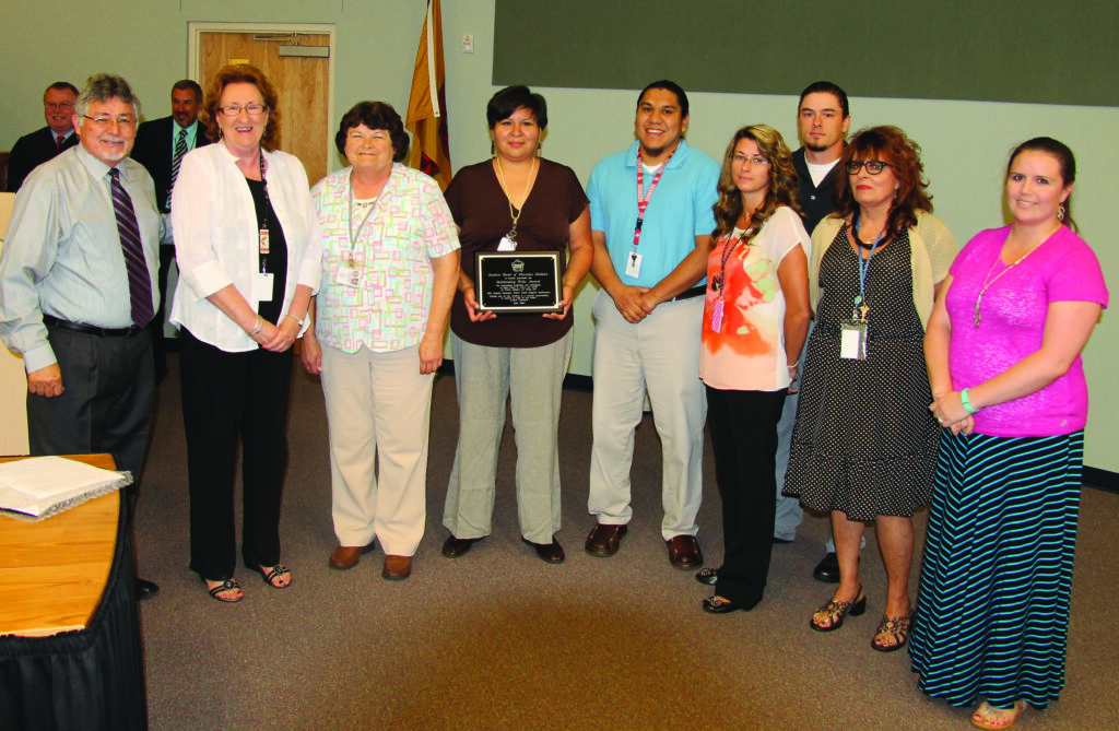 Jerry Sweet (left) presents the NTCSA Outstanding Tribe Award to the EBCI Child Support Program staff.  