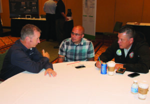 Gregory A. Bramham (left), chief executive officer of Global Com, speaks with Wolfetown Rep. Bo Crowe and Cherokee County – Snowbird Rep. Brandon Jones during Wednesday’s Expo.  