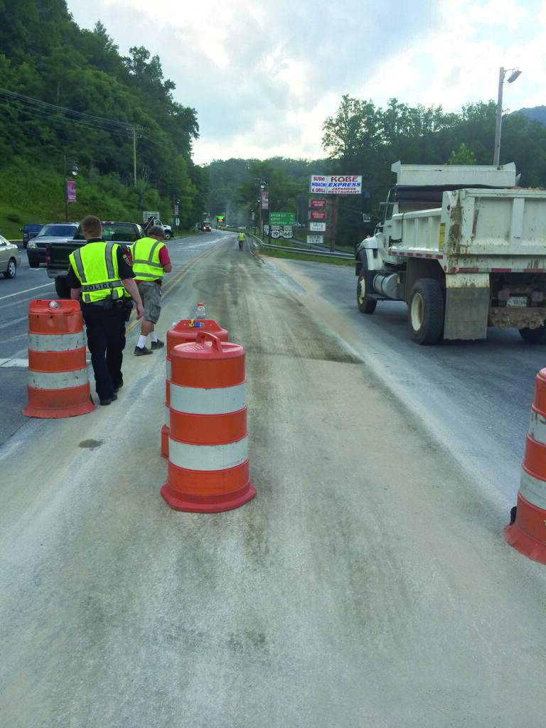 Crews use sand to clean up a Bio-diesel spill on US19 in Cherokee on Thursday, July 24.  (Photo courtesy of EBCI Public Safety) 