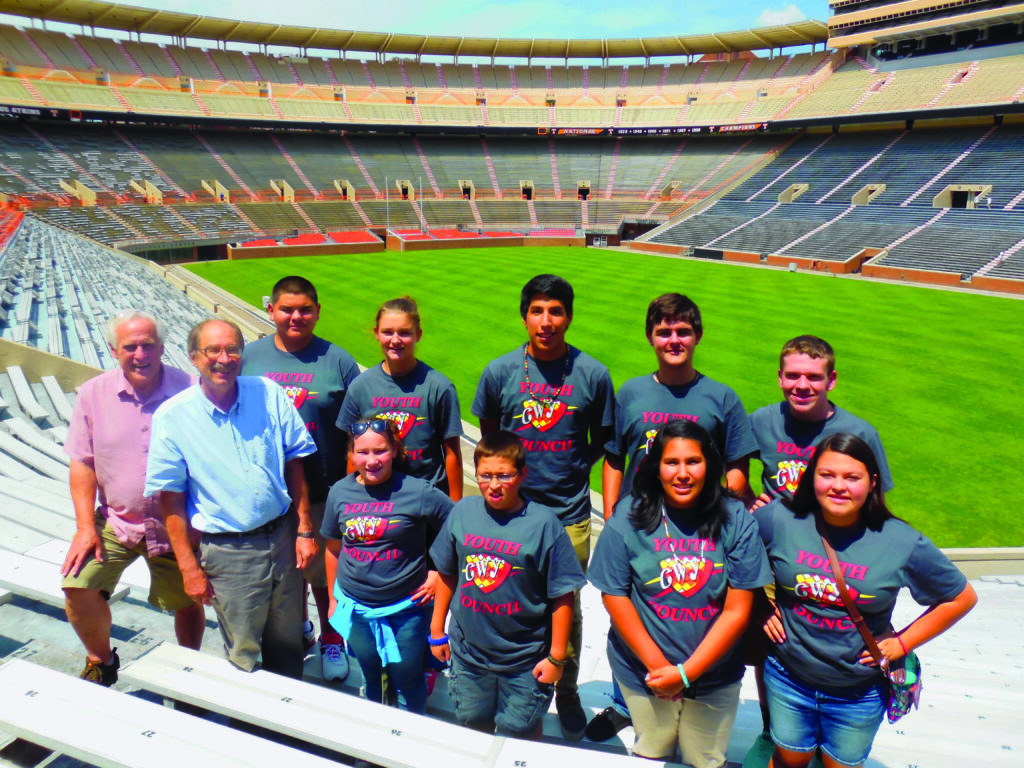 The Cherokee Youth Council is shown with University of Tennessee staff (left-right) during a tour of Neyland Stadium: front row – Dr. Gerald Schroedl, Evelyn Cotterman, Dallas Bennett, Louwana Montelongo, Kara Welch; back row – Roger Clapp, Jullian Rubio, Hope Long, Simon Montelongo, Jacob Long, and Trevor Cagle.   (Photo by Sky Sampson/Cherokee Youth Council) 
