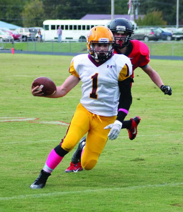 Tye Mintz (#1), JV Braves quarterback, outruns an Andrews defender on a 15-yard touchdown run in the first quarter of a game at Andrews on Thursday, Oct. 9 that Cherokee won 40-16.  (SCOTT MCKIE B.P./One Feather) 
