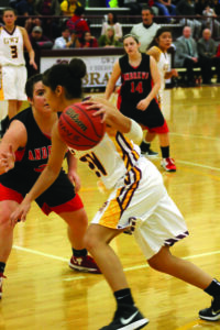 Tiffani Riggins (#24), Lady Braves senior guard, dribbles past Andrews’ Haley West (#32) in the second half of Tuesday’s home game.  Riggins had 10 points on the night. 