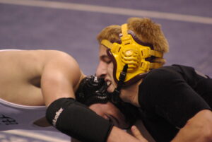 Bradley wrestles Mitchell’s Dalton Beaver in the 145lb first place match.  (Photo by Vickie McCoy) 