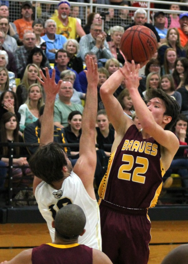 Dustin Johnson (#22), Braves senior point guard, shoots over Hayesville’s Vance Rhyne (#10) during an away game on Friday, Jan. 30.  Johnson led Cherokee with 16 points, four rebounds and a steal.  (SCOTT MCKIE B.P./One Feather) 