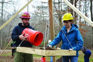 Forest Service employees work alongside volunteers to shift through soil one bucket load at a time.  