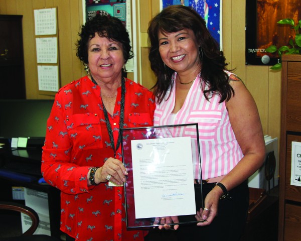  Johnna Blackhair (right),  Acting Regional Director of the BIA Eastern Region, presents Darlene Whitetree with a Letter of Appreciation from the US Department of the Interior Bureau of Indian Affairs.  (AMBLE SMOKER/One Feather) 