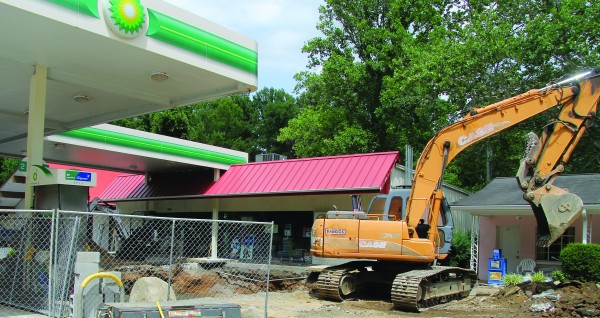 Crews from Chris Singleton Environmental work on removing a fuel tank at Cherokee Mini-Mart on Tuesday, June 23.  (SCOTT MCKIE B.P./One Feather photos) 