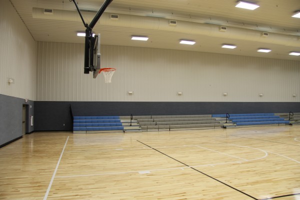 The 12,000 square foot community center has been built on a 2.1 acre lot and includes a full-size gym with hardwood floors (shown in photo), a kitchen, a community room, a workout room and office spaces.  
