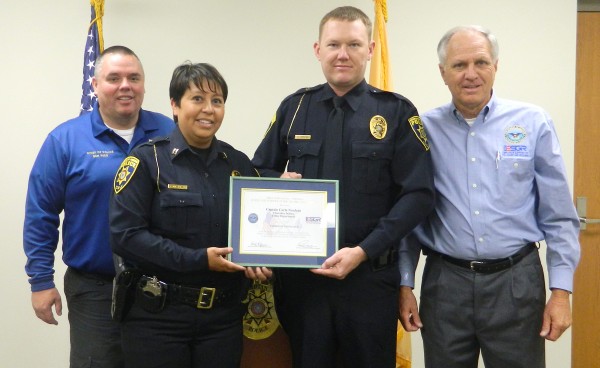 Employer Support of the Guard and Reserve (ESGR) volunteer, Pete Haithcock (right) presented the Patriot Award to Captain Carla Neadeau (2nd from left) of the Cherokee Indian Police Department on Wednesday, Sept. 23. Shown (left-right) are Cherokee Chief of Police Ben Reed, Neadeau, Patrolman Travis L. Brooks, and Haithcock.  (CIPD photo) 